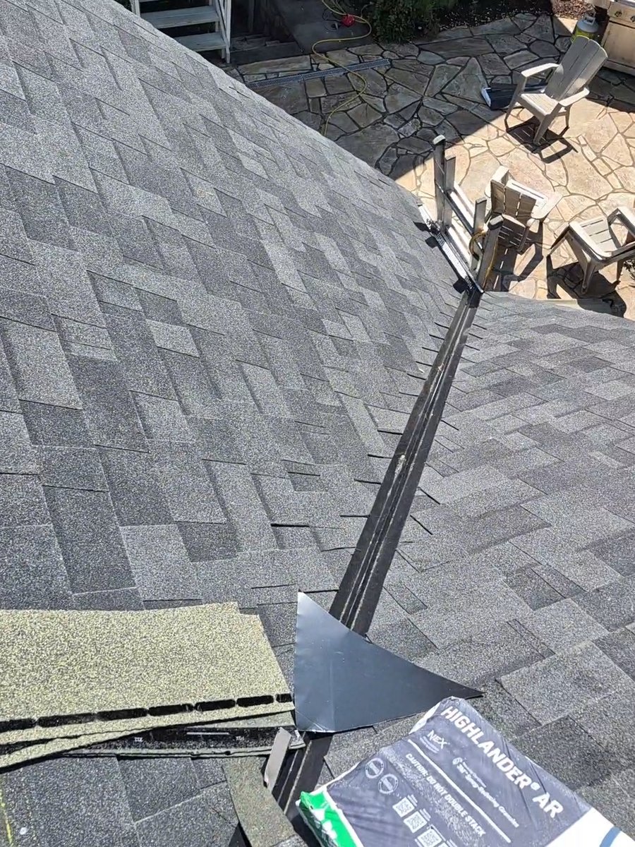 Gray shingle roof meeting at a flashed valley