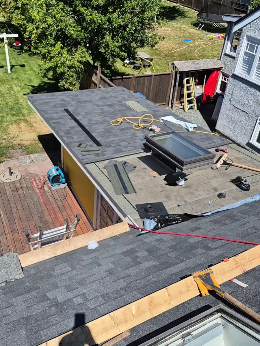 Roof decking with a skylight opening, tools and shingles